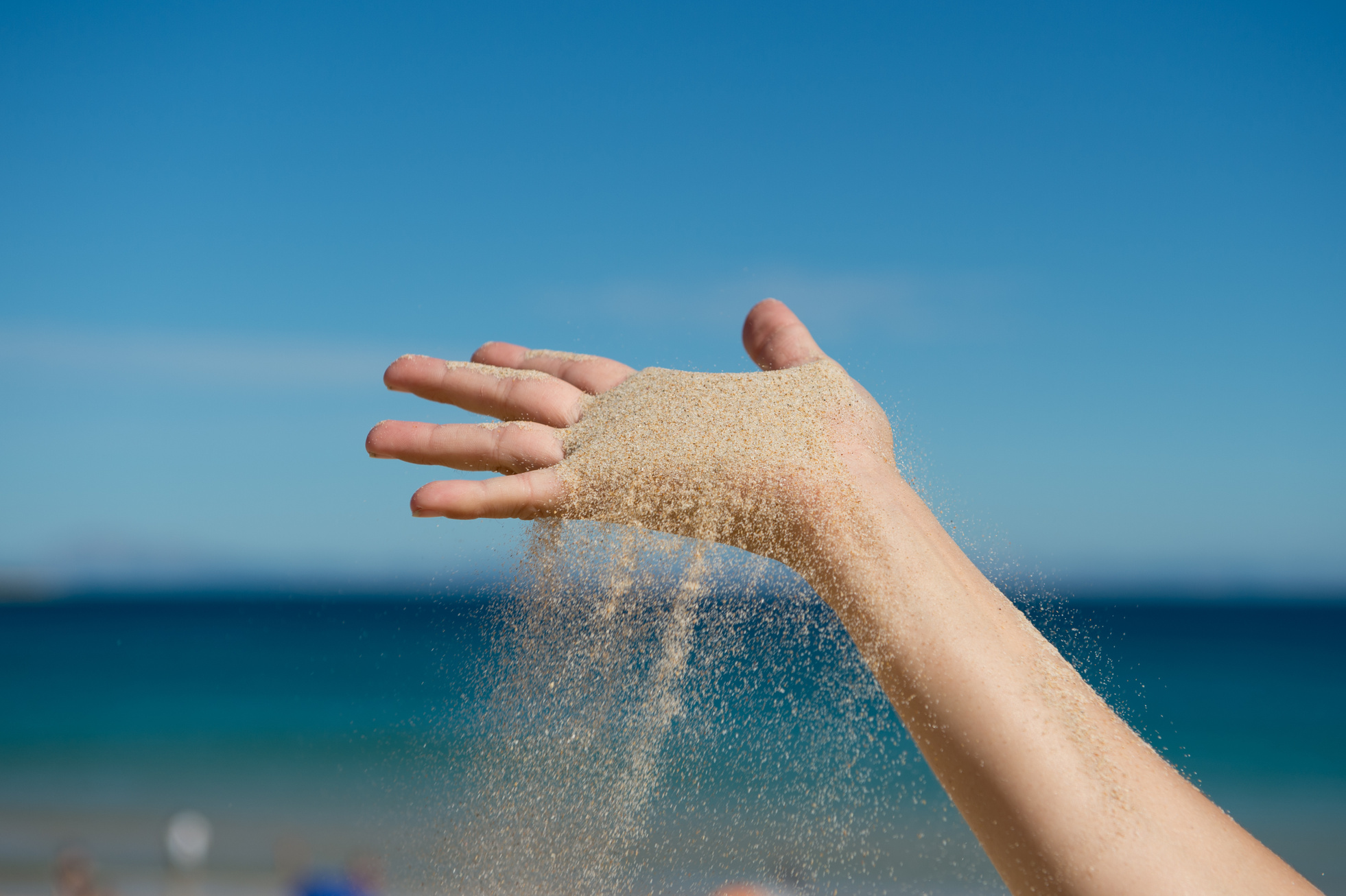 sand grains falling from a hand